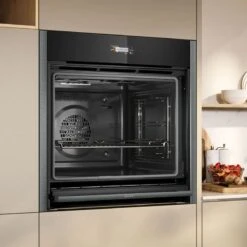 Neff N70 B54CR71G0B Bulit In Single Slide & Hide Pyrolytic Oven With Home Connect - Black With Graphite Grey Trim -Kitchen Series Shop n e neff n70 b54cr71g0b slide and hide pyrolytic oven lifestyle3